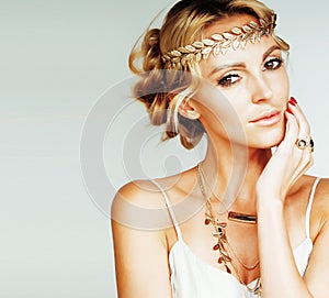 young blond woman dressed like ancient greek godess, gold jewelr