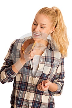 Young blond woman eating breakfast bread and nougat spread isolated over white background