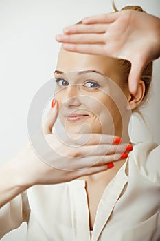 Young blond woman emotional in studio isolated gesturing, making goofy faces, lifestyle people concept