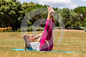 Young blond woman exercising, toning up muscles