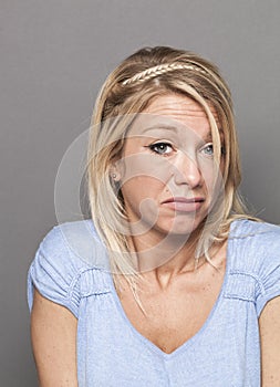 Young blond woman expressing careless arrogance