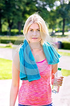 Young blond woman finished with jogging.