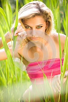 young blond woman in green grass