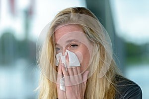 Young blond woman with hay fever