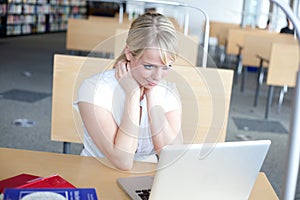 Young blond woman with laptop