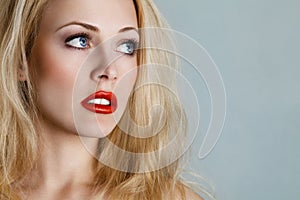 Young blond woman looking up