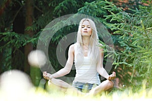 Young blond woman in lotus pose