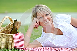 Young Blond Woman on Picnic with Wine