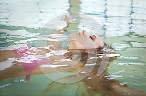 Young blond woman relaxing in the water