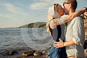 Young Blond Woman Smooching Boyfriend At Beach photo