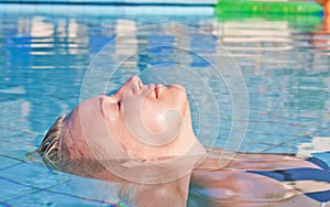 Young blond woman in swimming pool