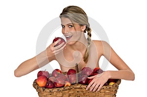 Young blond woman taking a bite of a red apple