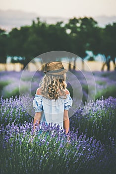 Young blond woman traveller standing in lavender field, Isparta, Turkey