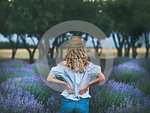 Young blond woman traveller standing in lavender field in Turkey