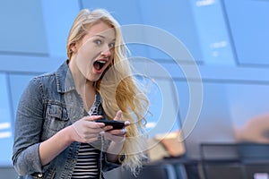 Young blond woman writing text messages