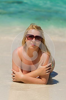 Young blonde beautiful woman at the beach in bikini