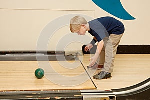 Child bowling with ball