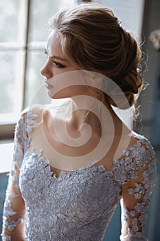 Young blonde bride woman in a light blue wedding dress