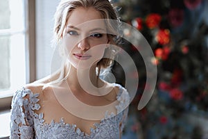 Young blonde bride woman in a light blue wedding dress