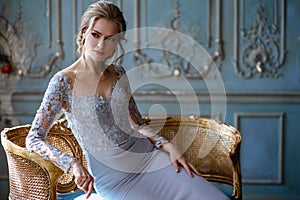 Young blonde bride woman in a light blue wedding dress