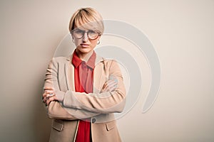 Young blonde business woman with short hair wearing glasses and elegant jacket skeptic and nervous, disapproving expression on