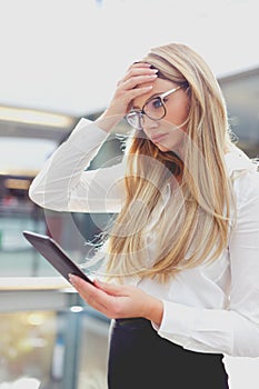 Young blonde businesswoman forget task in business center