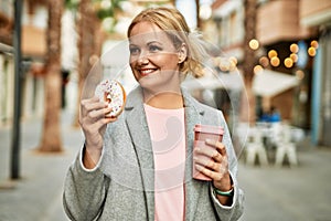 Young blonde businesswoman having breakfast at the city