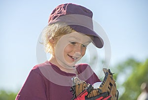 Young blonde caucasian boy catching his first baseball