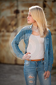 Young blonde caucasian girl alone on a street