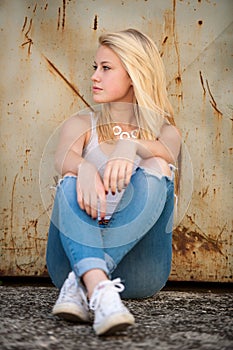 Young blonde caucasian girl alone on a street