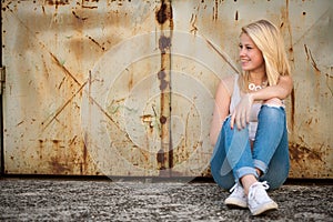 Young blonde caucasian girl alone on a street