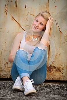 Young blonde caucasian girl alone on a street