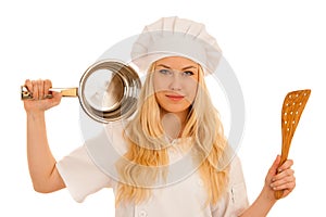 Young blonde chef woamn holds kitchenware as she prepares to coo