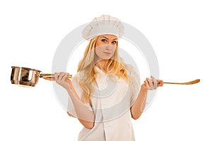 Young blonde chef woamn holds kitchenware as she prepares to coo