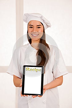 Young blonde chef woamn holds kitchenware as she prepares to coo