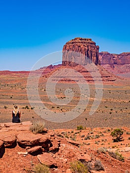 Young blonde girl admires panorama from Artist`s Point in Oljato Monument Valley