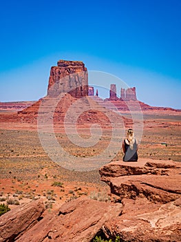 Young blonde girl admires panorama from Artist's Point in Oljato Monument Valley photo