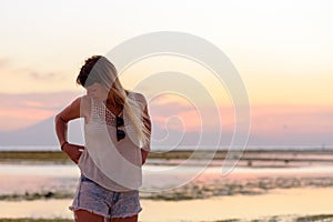 Young blonde girl on Gili Trawangan beach in Lombik, Indonesia at sunset time photo