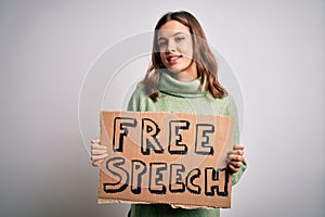 Young blonde girl holding protest banner with free speech message as rights freedom with a happy face standing and smiling with a