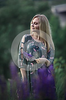 Young blonde girl with long hair lying in the grass.