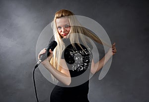 Young blonde girl with microphone