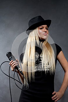 Young blonde girl with microphone
