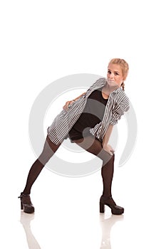 Young blonde girl in striped shirt and black stockings