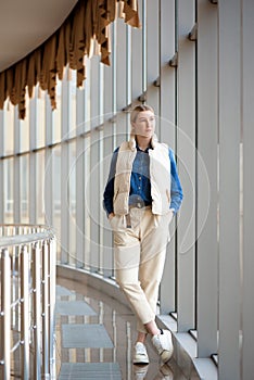 Young blonde girl is waiting for her departure at the airport.