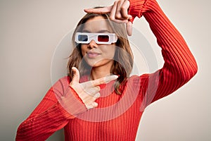 Young blonde girl wearing 3d cinema glasses over isolated background smiling making frame with hands and fingers with happy face