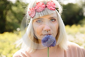 Young blonde hippie woman with onion and flower band