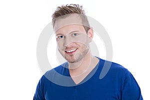Young blonde man with stubble in blue top looking at camera isolated on white background