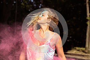 Young blonde model with long curly hair fluttering on wind with