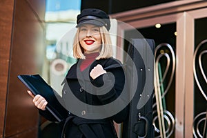 Young blonde musician woman smiling happy standing at the music academy