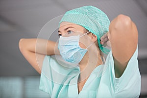 young blonde nurse in er room in surgical mask